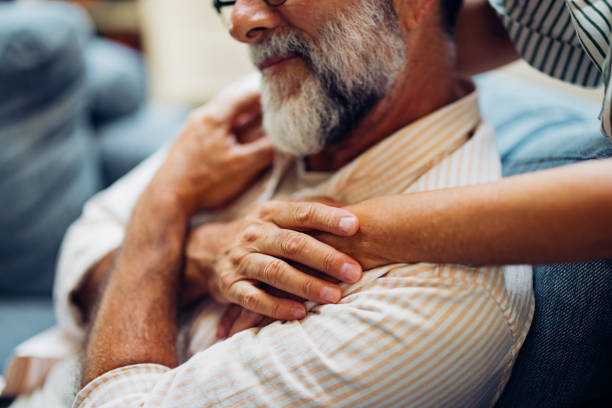 Elderly Man Embraced by Caring Hands in Home Setting