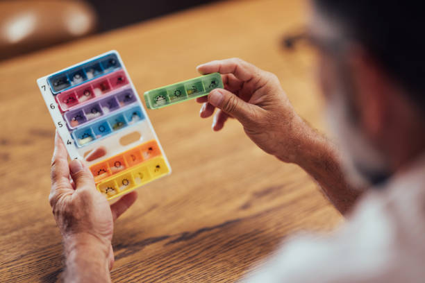 istock Senior Man Organizing Weekly Medication In Pill Box 2165132971