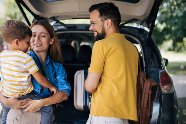 istock Family loading a car with luggage for a trip 2165133030