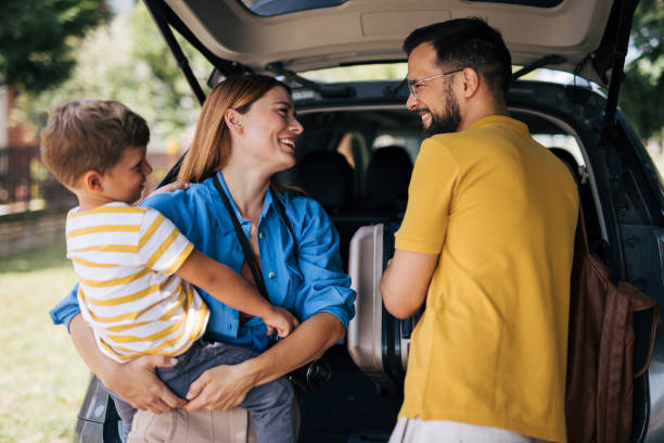 istock Preparing for a family trip, loading luggage into car 2165133042