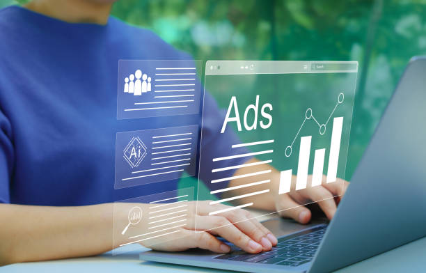 istock AI Analyzing Online Advertising Campaigns. Digital marketing concept. Person using laptop with virtual displays Ads and graphs, AI technology in digital marketing and online advertising analysis. AD, 2165133686