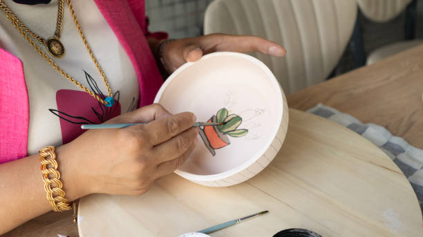 istock Close-up Woman hand drawing on ceramic plate 2165137860