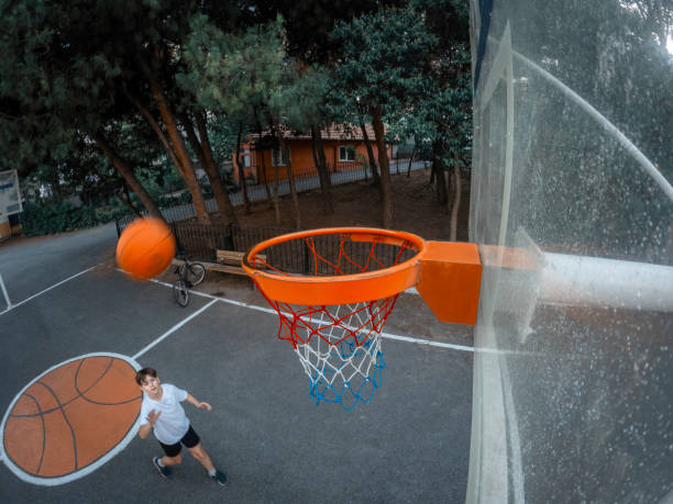 istock Young boy playing basketball in garden. 2165147937