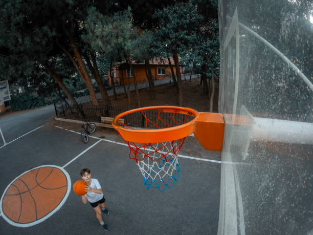 istock Young boy playing basketball in garden. 2165147944