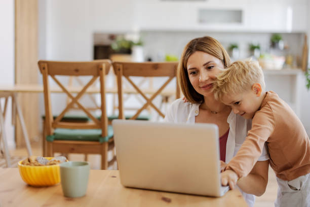 istock Mother and Little Preschool Cute Boy Using Laptop 2165149867