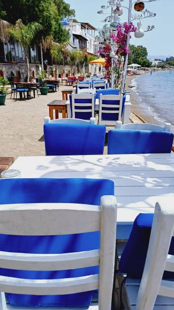 istock empty tables and chairs in restaurant by the sea 2165151186