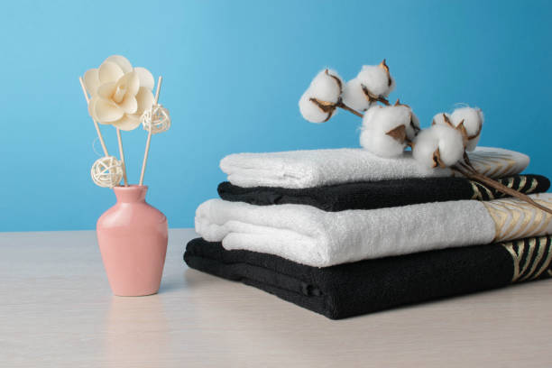 istock Minimalist Spa Decor with Stacked Towels, Cotton Flowers, and Aromatic Reed Diffuser 2165151465