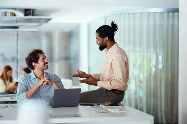 istock Coworkers Engaging in a Discussion in a Modern Office Setting 2165154337
