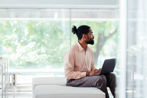 Businessman Working on Laptop in Bright Modern Office