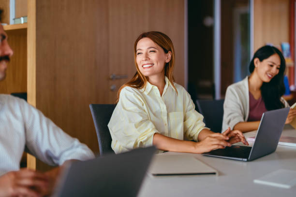 istock Smiling Coworkers in a Modern Office Environment 2165154392