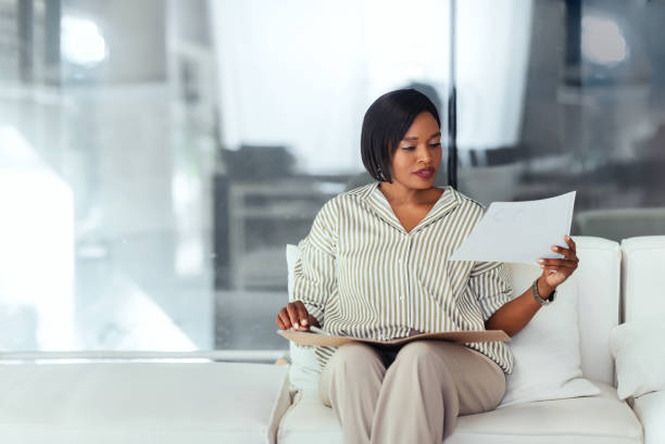 istock Professional Woman Reviewing Documents in Modern Office Setting 2165154405