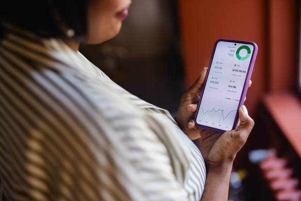 istock Woman Checking Financial Statistics On Her Smartphone 2165154424
