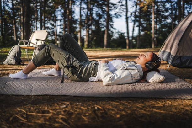 istock Young woman lying down on the grass have guided meditation 2165158439