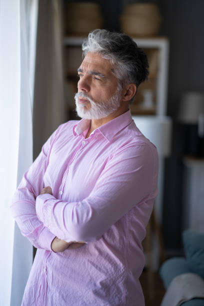 istock A man looking out of a window 2165160107