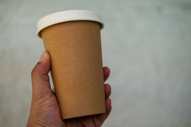 istock Cropped hand holding disposable cup with white lid 2165160228
