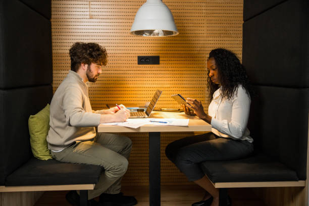 istock Focused Hispanic Male and Black Female Investors Analyzing Data 2165161417