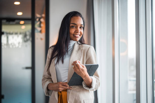 istock Confident Hispanic Businesswoman With Tablet 2165161455
