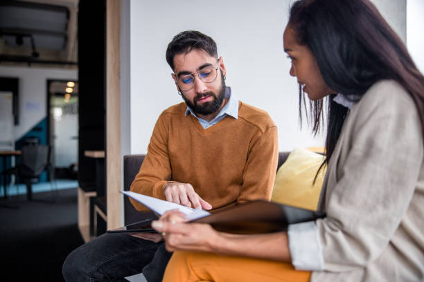 istock Hispanic Male and Female Investors Analyzing Documents 2165161458