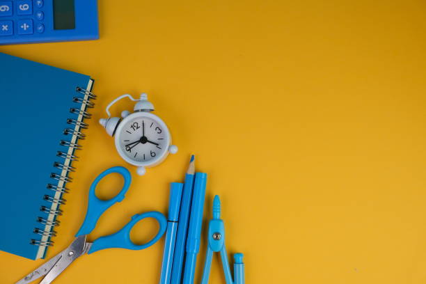 istock flatlay of a workplace with A cup of coffee, a laptop and a notebook, on a plain background. Education, business and office concept. 2165161761