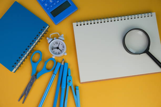 istock flatlay of a workplace with A cup of coffee, a laptop and a notebook, on a plain background. Education, business and office concept. 2165161766