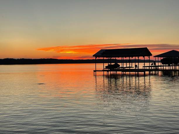 istock Sunset on lake with a dock in the background. 2165164054