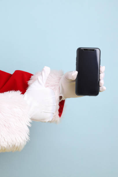 istock Santa holding mobile phone 2165168170