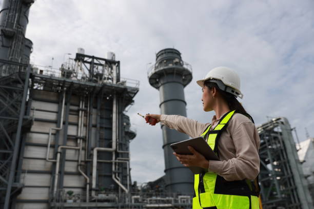 istock A female energy engineer is effectively utilizing a tablet and walkie talkie at a medium-sized power plant located in an industrial estate. 2165172360