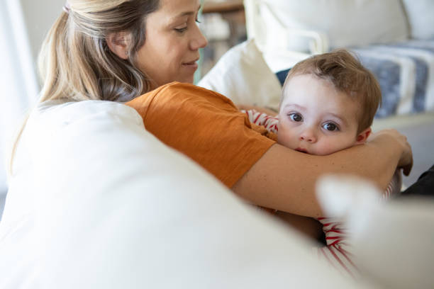 Young mother lovingly breastfeeding her baby son - Buenos Aires - Argentina