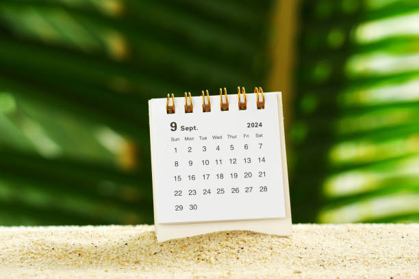 istock Desk calendar for September 2024 on table with bokeh nature background 2165174103