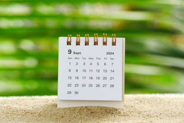 istock Desk calendar for September 2024 on table with bokeh nature background 2165174105