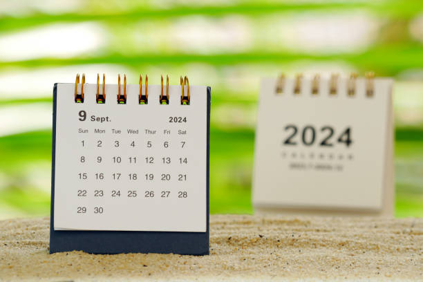 istock Desk calendar for September 2024 on table with bokeh nature background 2165174113