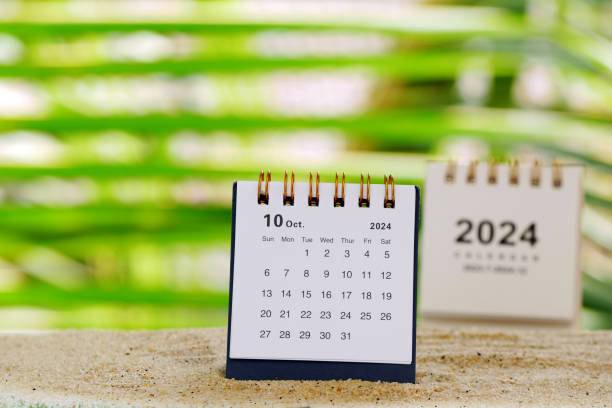istock October 2024 desk calendar on sand with natural bokeh background 2165174186