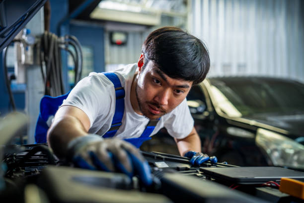 istock Professional Auto Mechanic Conducting Vehicle Inspection and Maintenance with Digital Tools in a Modern Automotive Garage. 2165178706