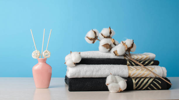 istock Spa Towels and Cotton Branch with Aromatic Diffuser on Light Wooden Table against Blue Background 2165179210