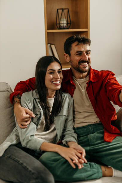 istock Embraced couple enjoying TV time 2165185012