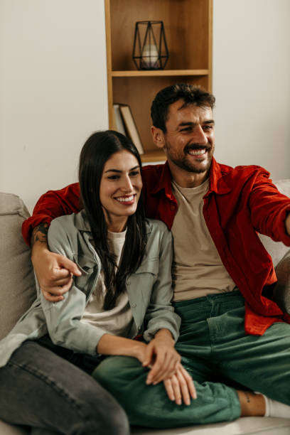 istock Embraced couple enjoying TV time 2165185019
