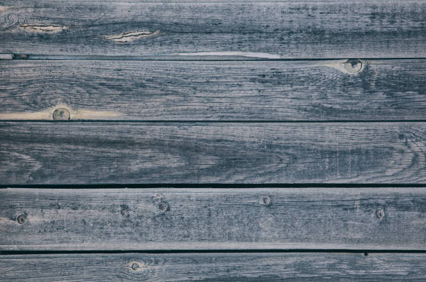 istock A fence made of pine boards. Old, worn, cracked board. Texture, background. 2165186184