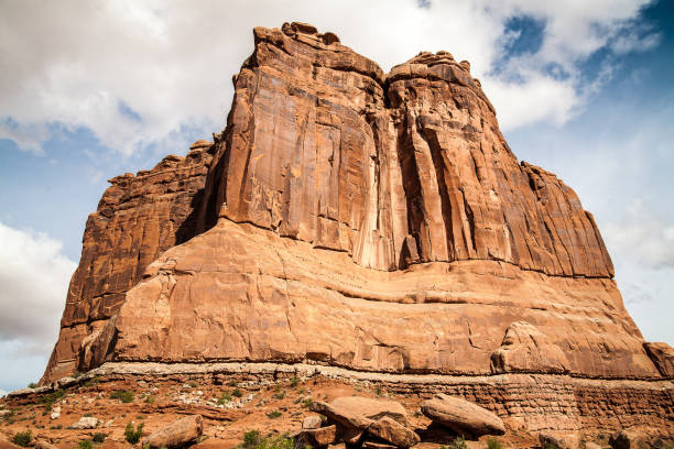 Amazing rock shapes in Arches National Park in Utah, USA. The photo taken on a sunny day with white clouds in the blue sky highlights the beauty of the rocks.