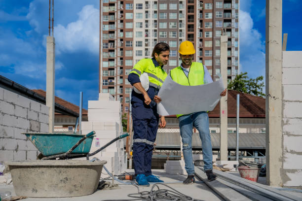 istock Professional Engineers and Architects Discussing Blueprints at a Construction Site for a Commercial Real Estate Development Project 2165192450
