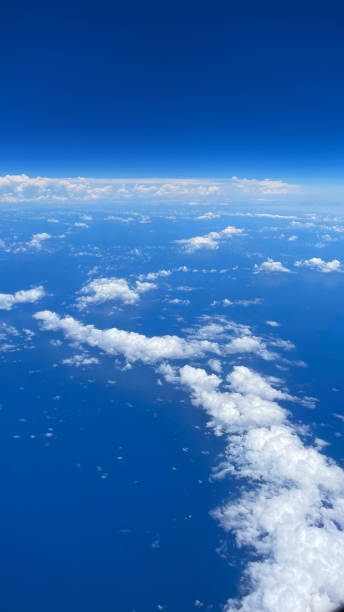 VERTICAL VIDEO, Aerial view from airplane window above cloud.