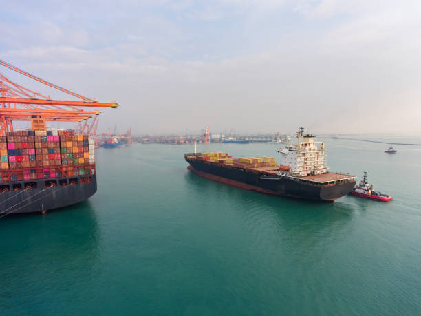 istock Aerial view of Cargo Container Ship approaching port with tugboat. 2165198372