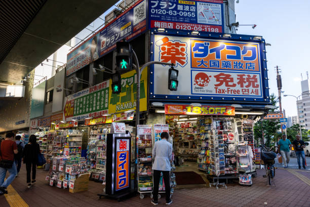 Osaka, Japan - June 18, 2024 : Pedestrians walk past the Daikoku Drug Store in Osaka, Japan.