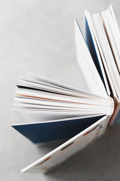 istock Open book against white wall with copy space, Book Lover 2165199501