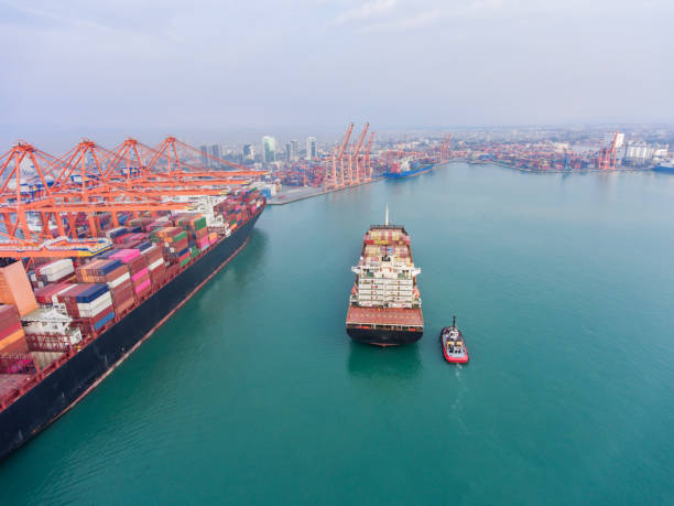 istock Aerial view of Cargo Container Ship approaching port with tugboat. 2165199978