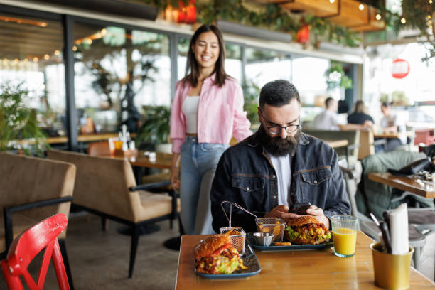 istock Happy couple in burger bar 2165200179