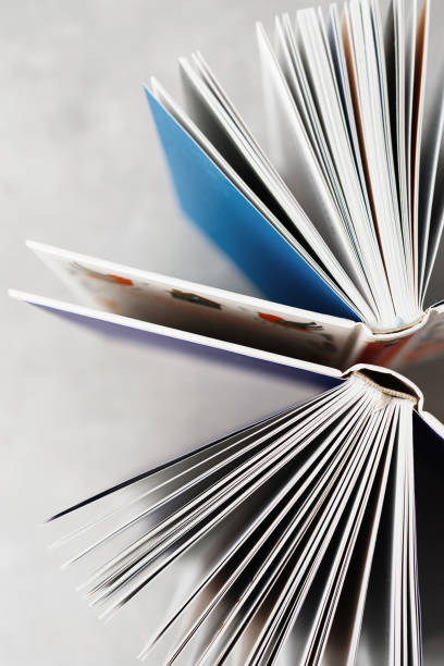 istock Open book against white wall with copy space, Book Lover 2165200187