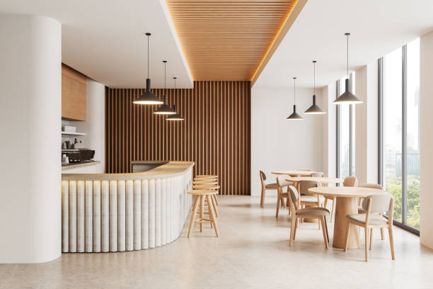 istock Stylish restaurant interior with bar counter, dining table with chairs, window 2165201129