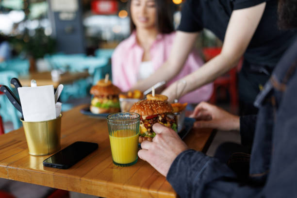 istock Happy couple ordering meal in local burger bar 2165201727