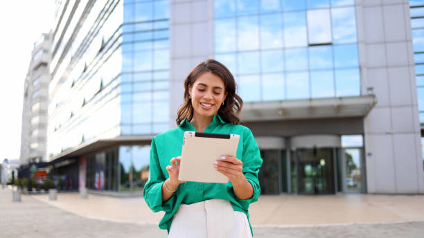 istock Businesswoman taking a break on the street and using tablet 2165202576
