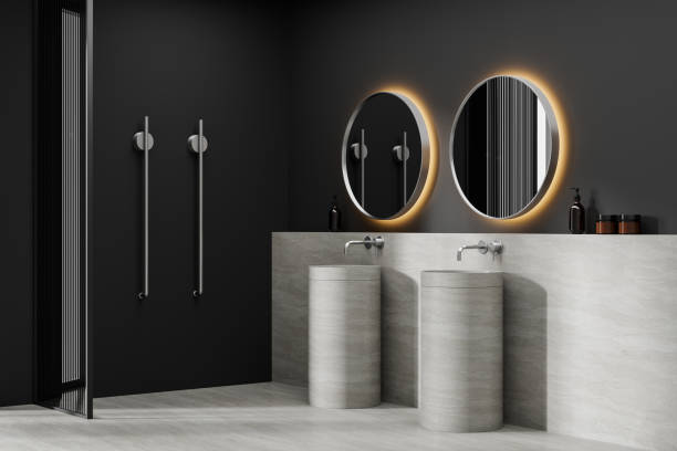 istock Modern bathroom interior with round mirrors and sleek fixtures, minimalistic design, light floor against dark walls, concept of contemporary home decor,  3D Rendering 2165202736